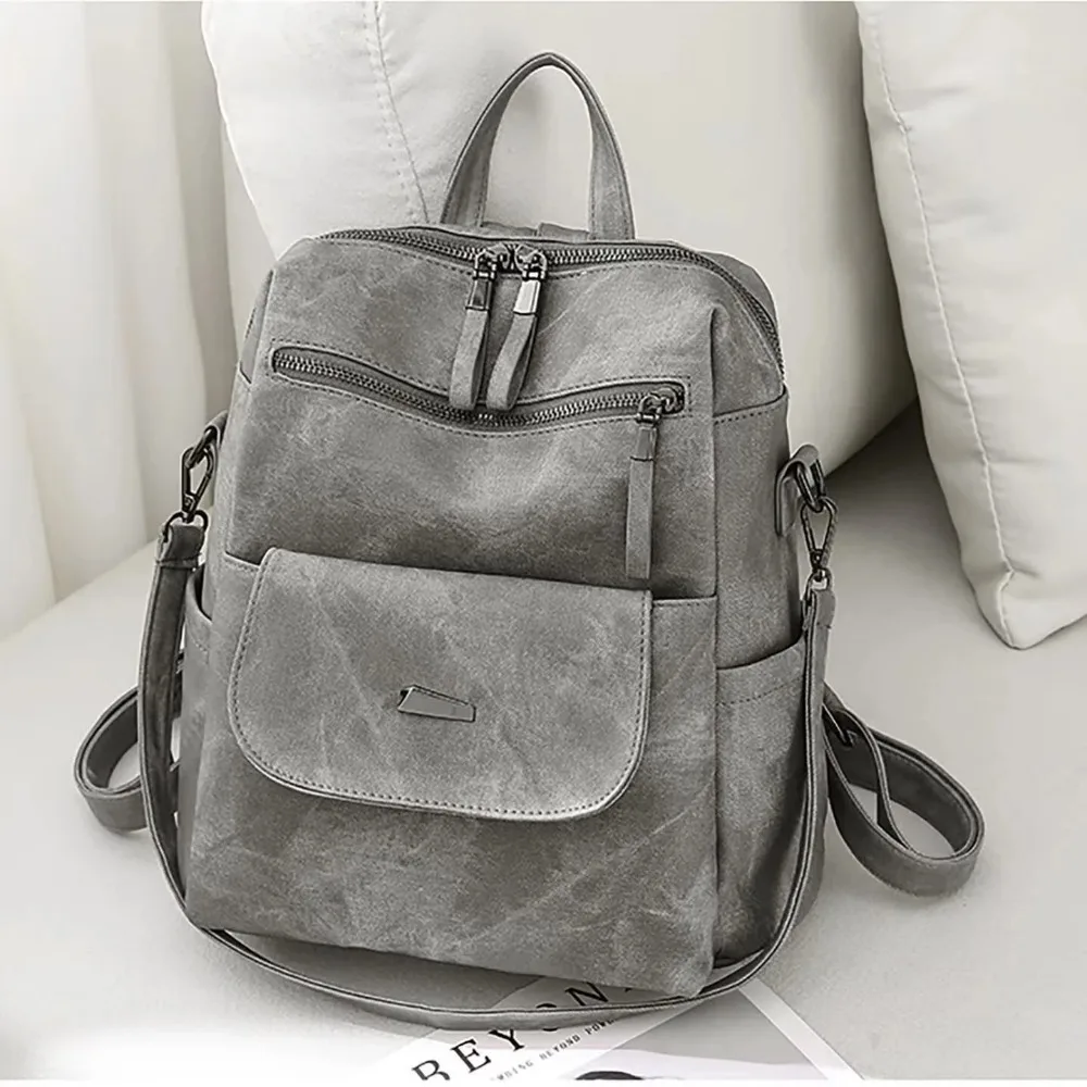 Close-up of high-quality stitching and hardware details on a women's leather backpack